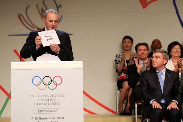 IOC President Jacques Rogge announces that he will be succeeded by Thomas Bach, as the German looks on 