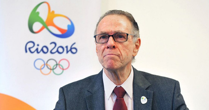 Carlos Nuzman_in_front_of_Rio_2016_logo_and_wearing_pin_badge