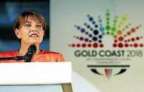 Anna Bligh_in_front_of_Gold_Coast_2018_logo
