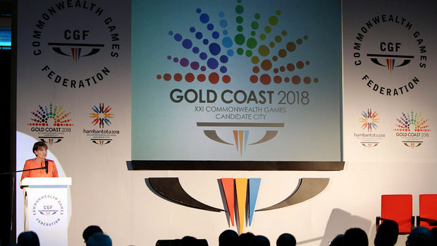 Anna Bligh_in_front_of_Gold_Coast_2018_logo