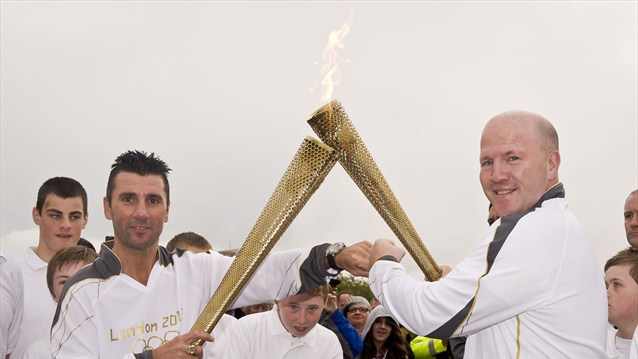 Michael Carruth_receives_the_flame_from_Wayne_McCullough_Ireland_June_6_2012_2