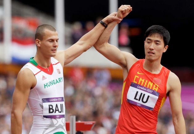Balazs Baji_raises_the_arm_of_Liu_Xiang_after_his_fall_during_the_mens_110m_hurdles