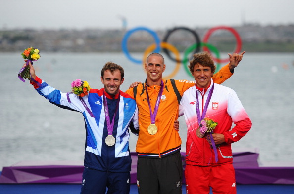 Gold medallist_Dorian_Van_Rijsselberge_C_of_Netherlands_celebrates_with_silver_medallist_Nick_Dempsey_L_of_Great_Britain_and_bronze_medallist_Przemyslaw_Miarczynski_R_of_Poland