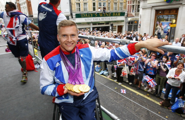 British quadruple_gold_medal_winning_Paralympian_David_Weir_shows_his_four_gold_medals_as_he_takes_part_in_the_London_2012_Victory_Parade_for_Team_GB_and_ParalympicGB_athletes
