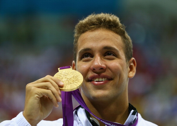 Chad le_Clos_poses_on_the_podium_during_the_medal_ceremony_for_the_mens_200m_butterfly_at_London_2012
