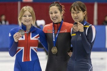 Elise Christie_left_of_Great_Britain_with_the_silver_Valerie_Maltais_center_of_Canada_with_the_gold_and_Ha-Ri_Cho_of_Korea_30-10-12