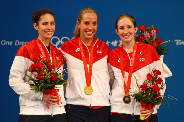 Becca Ward Sada Jacobson and Mariel Zagunis pose on the podium with the bronze medal for the Womens Team Sabre