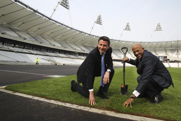 Frankie Fredericks and Sebastian Coe at Olympic Stadium lying truf
