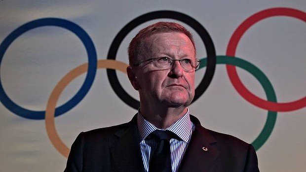John Coates in front of Olympic rings