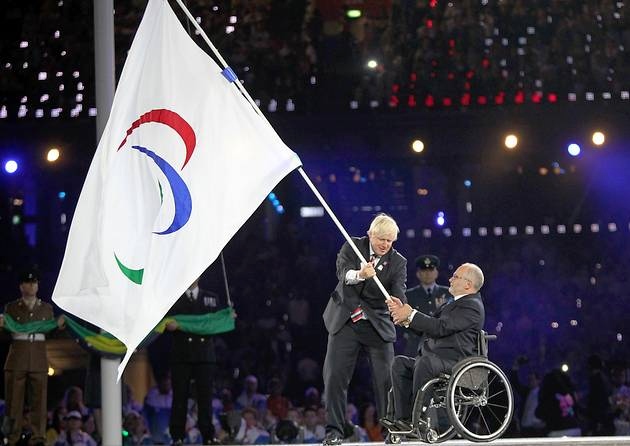 Sir Philip Craven at London 2012 Closing Ceremony with Boris Johnson and Paralympic flag