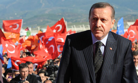 Recep Tayyip Erdoğan in front of Turkish flags