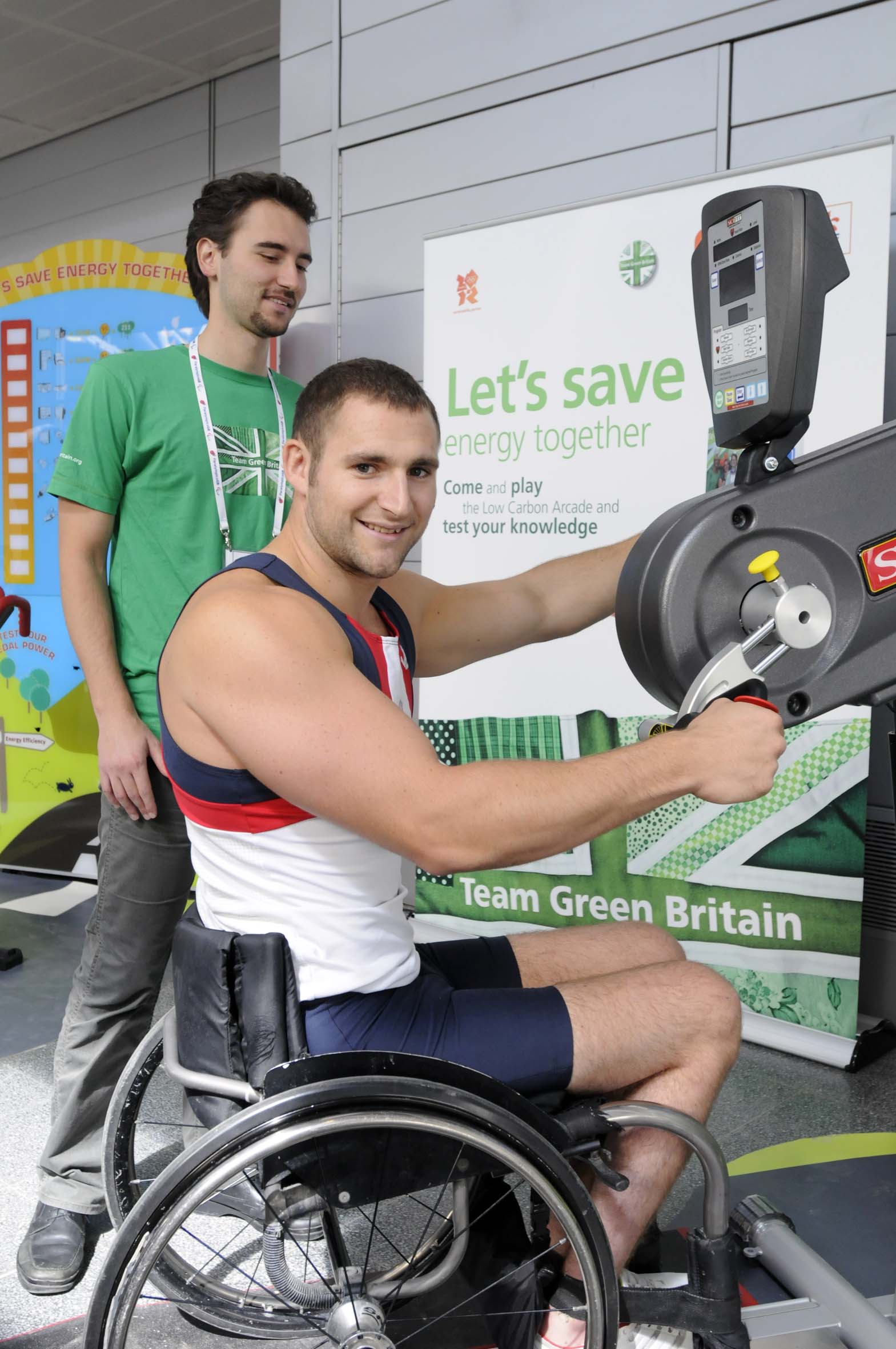 Tom Aggar gold medal winner in mens single scull rowing at the Beijing Paralympics demos the energy producing stationary hand cycle