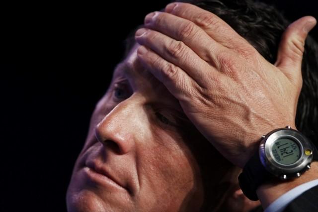 Lance Armstrong with hand on head