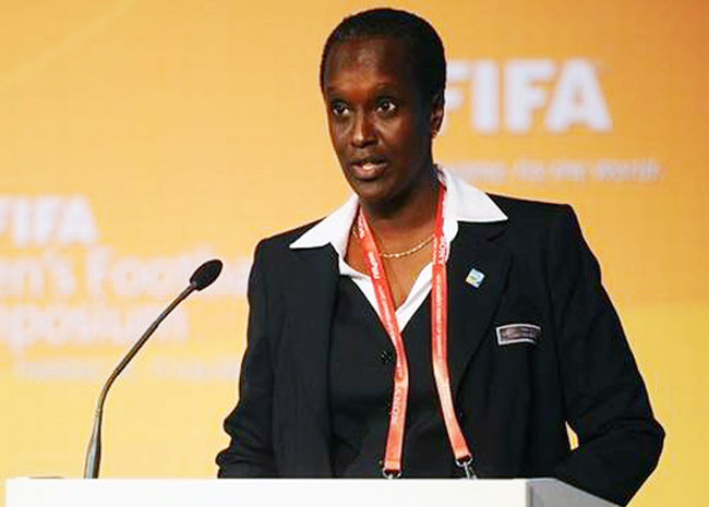 Lydia Nsekera in front of FIFA logo