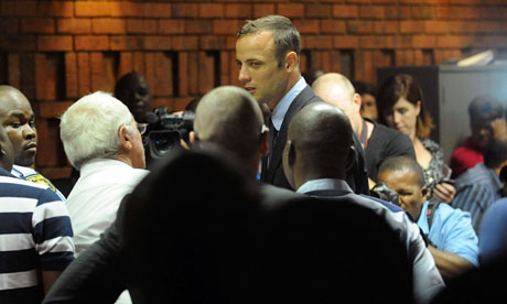 Oscar Pistorius leaves court in Pretoria after being formally charged with the murder of his girlfriend Reeva Steenkamp