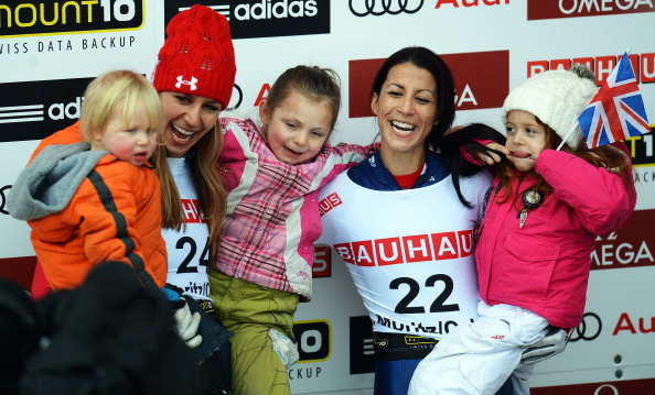 Shelley Rudman of Great Britain celebrates with her daughter Elli next to second placed Noelle Pikus Pace of USA