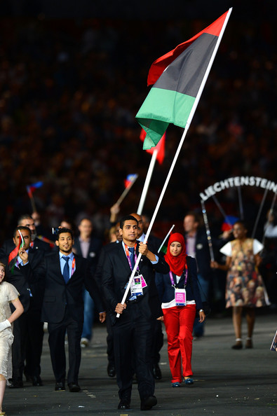 El-Gadi Sofyan of the Libya Olympic swimming team carries his countrys flag during the Opening Ceremony of the London 2012 Olympic Games at the Olympic Stadium on July 27 2012 in London England