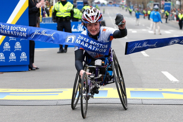Tatyana McFadden crosses the finish line to win the womens wheelchair division of the 2013 Boston Marathon