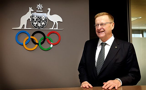 John Coates in front of AOC logo and Olympic rings