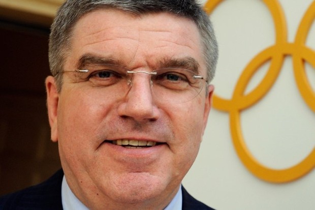 Thomas Bach in front of Olympic rings