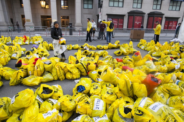 A volunteer sorts through unclaimed runners bags after two explosions occurred along the final stretch of the Boston Marathon