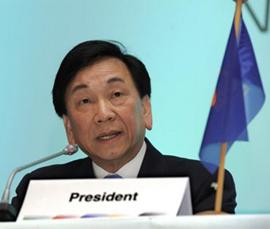 C K Wu behind Presidents name badge