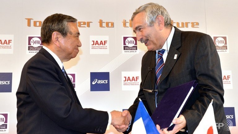 French Athletic Federation vice president Pierre Weiss R shakes hands with Yohei Kono president of the Japan Association of Athletics Federations in Tokyo on May 1 2013