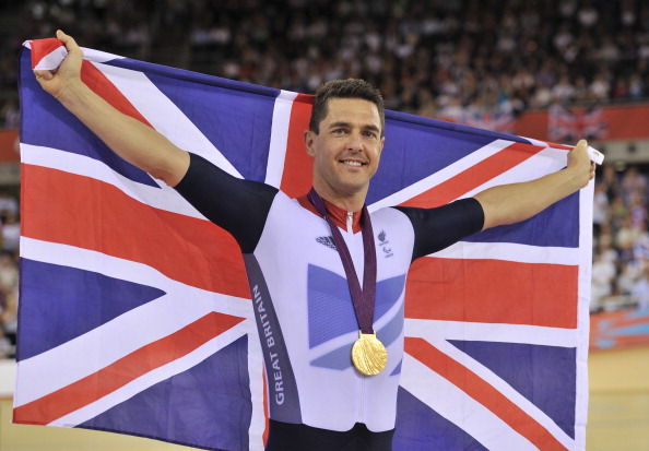 Britains Mark Lee Colbourne celebrates on the podium after winning the gold medal in the mens individual C1 pursuit final cycling event during the London 2012 Paralympic Games