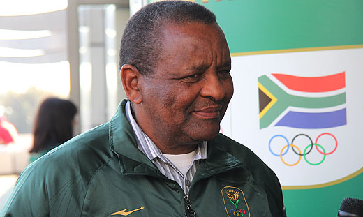 Gideon Sam in front of SA Olympic logo
