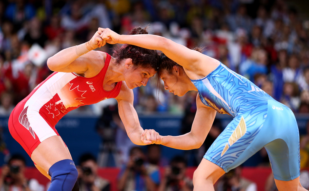 Saori Yoshida of Japan blue and Tonya Lynn Verbeek of Canada compete in the Womens Freestyle 55 kg Wrestling
