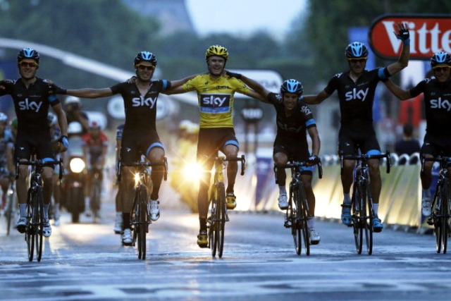 2013 Tour de France winner Chris Froome rides to victory down the Champs Elysées flanked by his Team Sky teammates