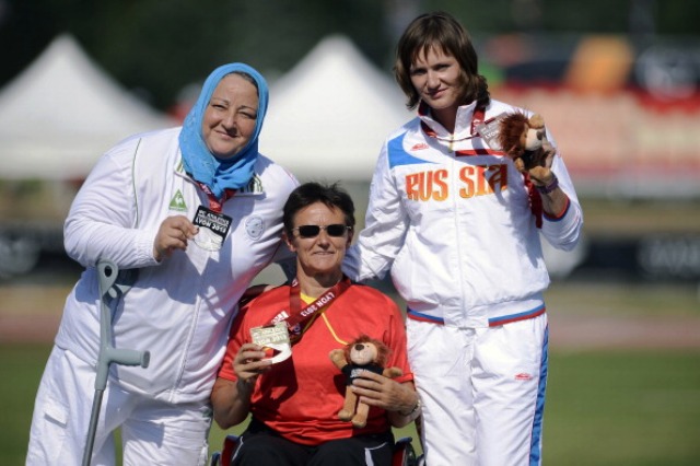 Germanys Martina Willing centre celebrates winning gold in the F555657 shot put during the 2013 IPC Athletics World Championships