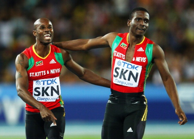 Kim Collins celebrates with teammate Jason Rogers of St Kitts and Nevis after securing bronze in the mens 4x100 metres relay final at Daegu 2011