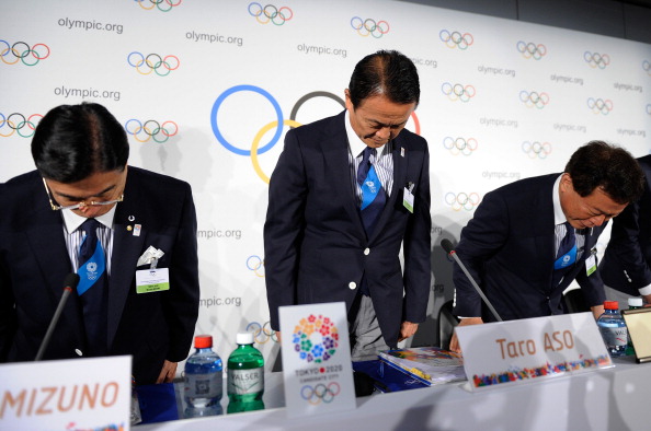 Masato Mizuno Taro Aso and Naoki Inose bow as they acknowledge IOC members in Lausanne