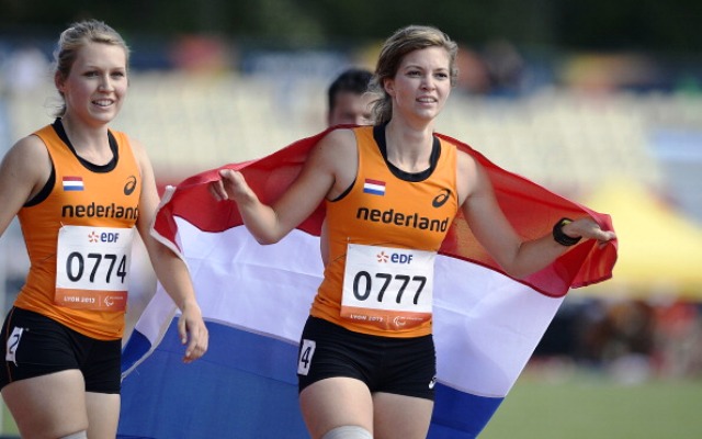 Paralympic champion Marlou van Rhijn right celebrates her sprint double in Lyon