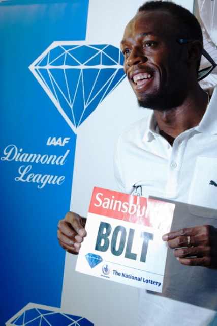 World 100m record holder Usain Bolt receives his race bib ahead of the London Anniversary Games