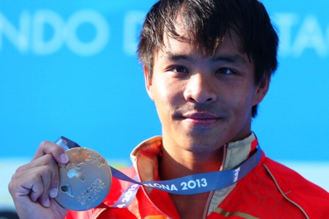 Chong He of China with his 3m diving gold medal at the FINA World Championships in Barcelona