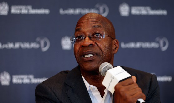 Edwin Moses talking into microphone