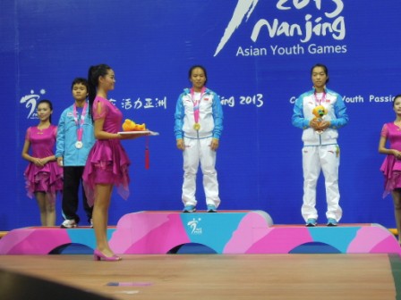 The first winner of the Asian Youth Games, China's Huihua Jiang, about to be presented with her gold medal by Sheikh Ahmad, President of the Olympic Council of Asia