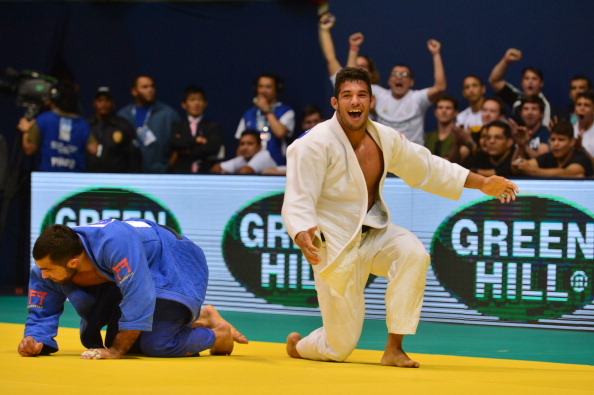 Cuba's Asley Gonzalez (white) celebrates after defeating Greece's Ilias Iliadis in the men's under 90kg category semi-final on his way to winning the title