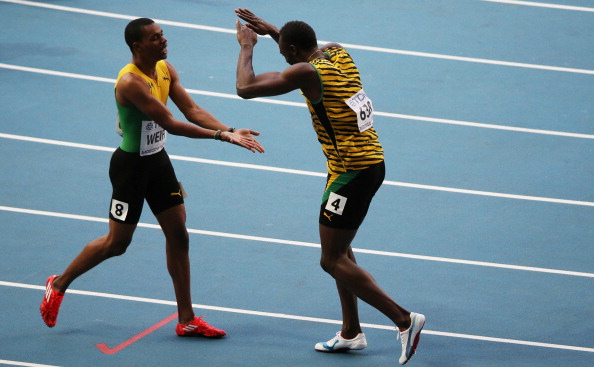 Jamaica's Usain Bolt celebrates with teammate Warren Weir after the won the gold and silver medals respectively in the 200 metres