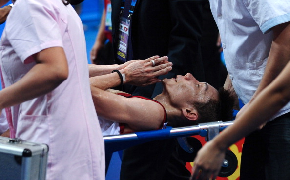 Lee Chong Wei was taken off on a stretcher after withdrawing from the men's singles World Championship final against Lin Dan