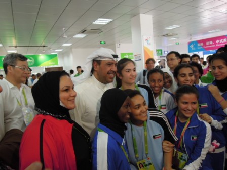 Sheikh Ahmad poses with competitors from his own country of Kuwait in the Athletes' Village