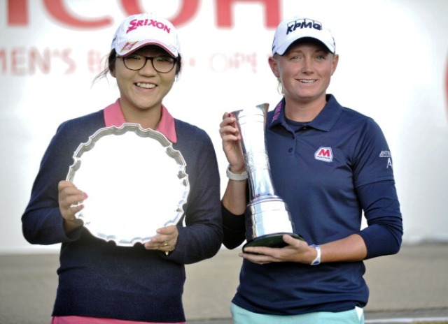 Stacy Lewis right poses with the Ricoh Womens British Open trophy alongside leading amateur Lydia Ko of New Zealand