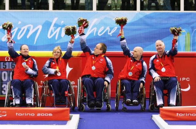 The British team celebrate their wheelchair curling silver medal at the 2006 Turin Winter Paralympic Games