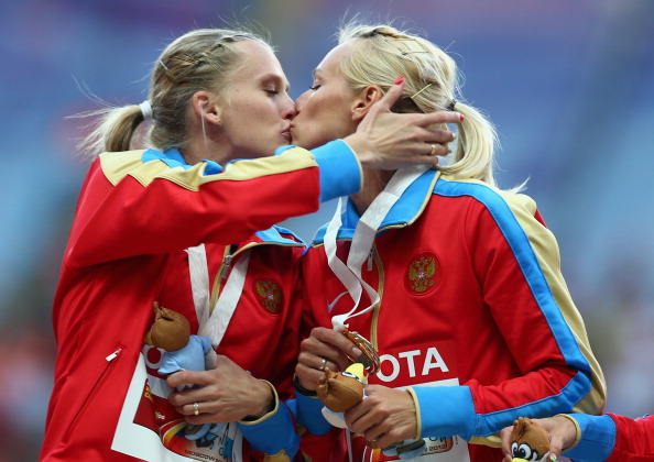 World Championship gold medalists Tatyana Firova and Kseniya Ryzhova of Russia kiss on the podium during the medal ceremony for the women's 4x400 metres relay, which some have claimed was a proest against their country's anti-gay laws