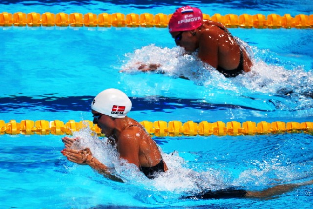 World record holder Rikke Pedersen of Denmark left and Russian Yulia Efimova battle it out in the final of the 200m breaststroke