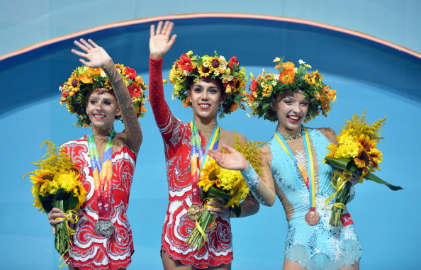 Yana Kudryavtseva, Margarita Mamun and Melitina Staniouta wave to the crowd on the ball podium of the 2013 Rhythmic Gymnastics World Championships