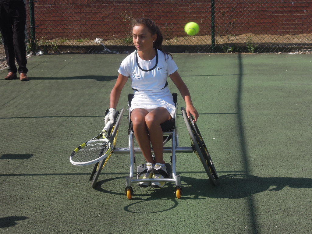 Young wheelchair tennis player Luz Esperanza Merry in action