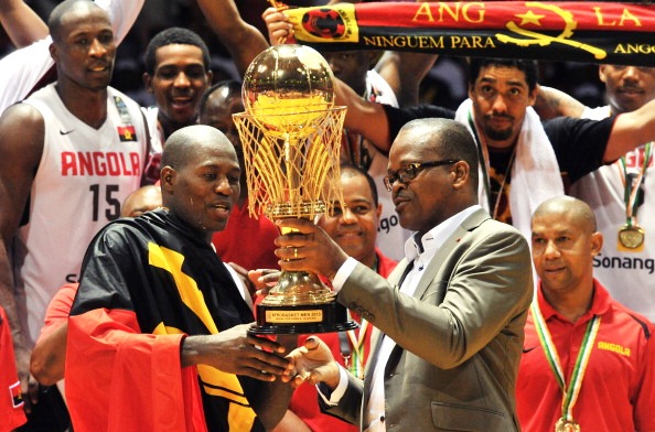 Angola captain Carlos Almeida receives the African Basketball Championship trophy from Ivory Coast sports minister Alain Lobognan